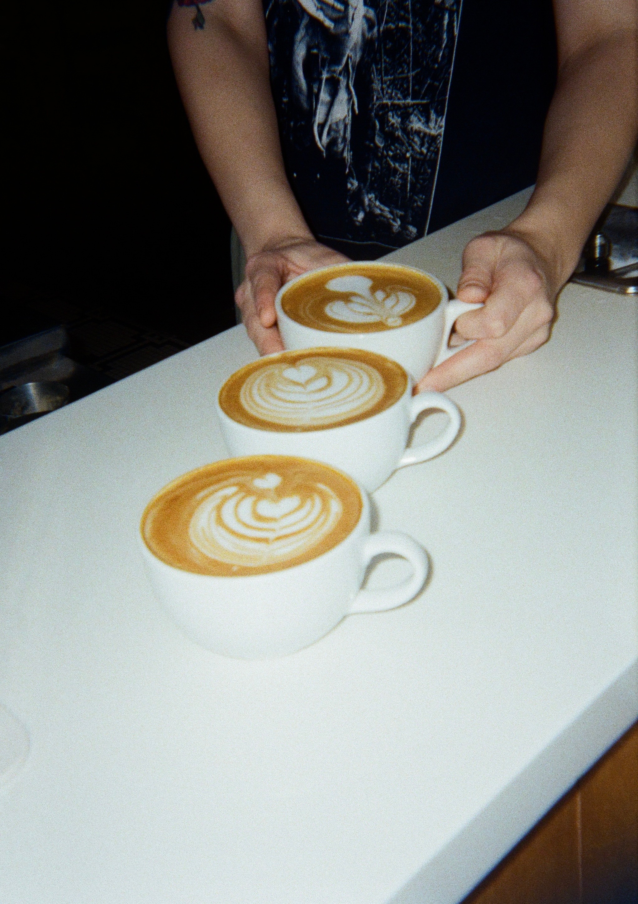 photo of a row of lattes on the counter